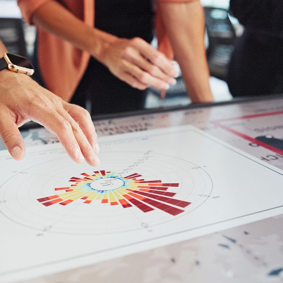 People analyzing chart on interactive screen